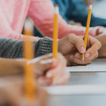 people writing a test on paper