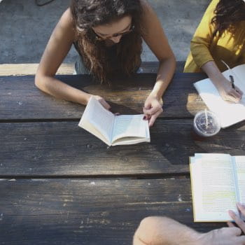 Girl book park table
